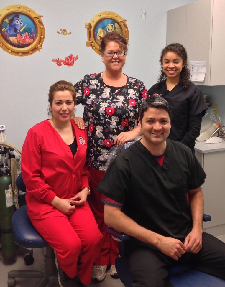 Dr. Diego Solis in the dental clinic with three staff members