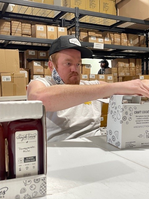 Kyle assembles boxes at Simple Times warehouse