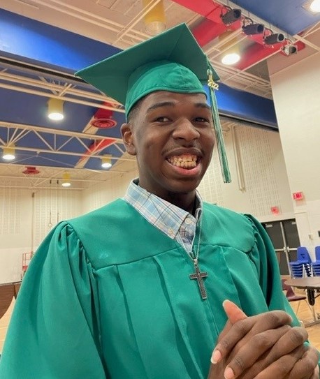 Smiling student wearing graduation cap and gown